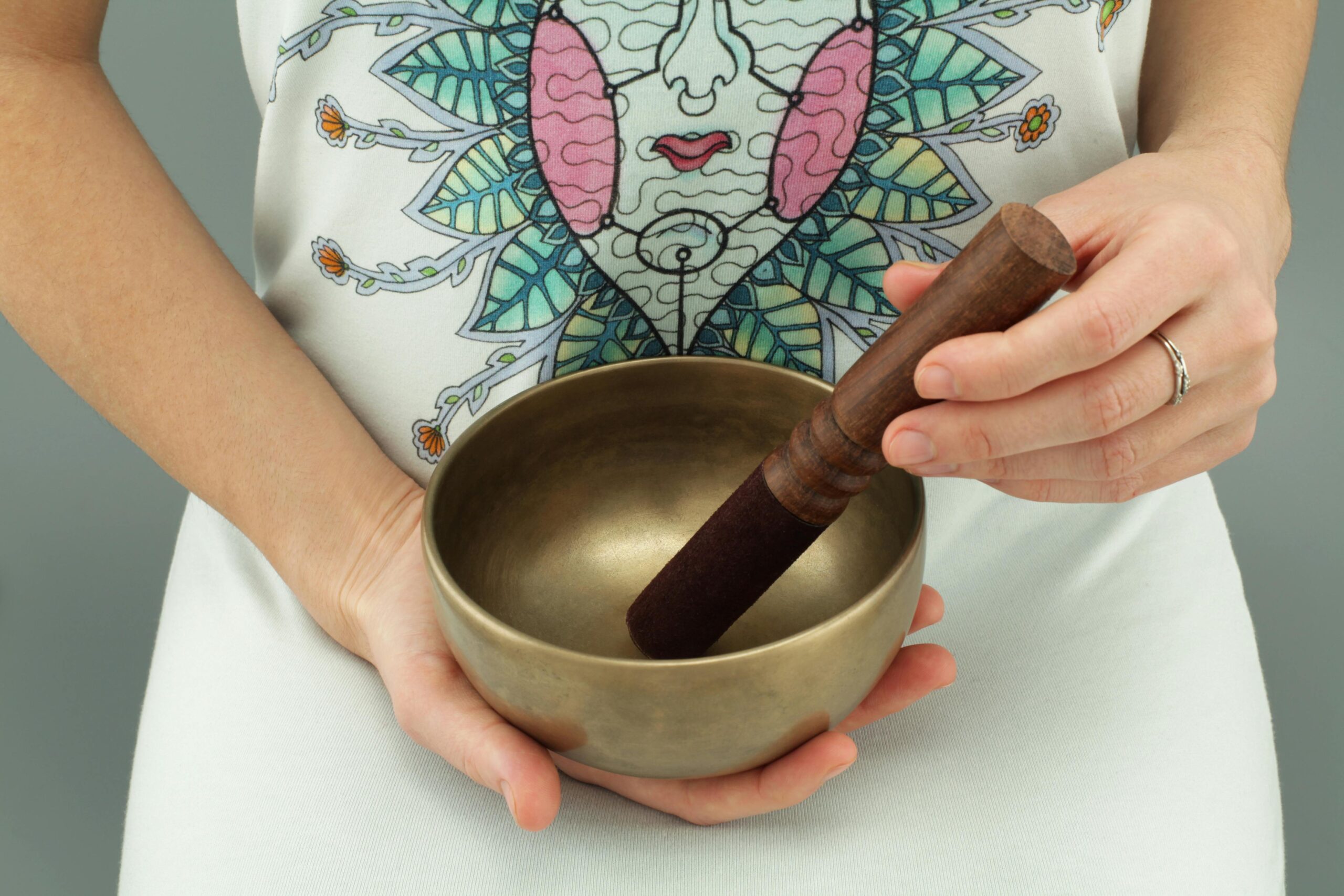 pexels-photo-3543711-3543711 Close-up of hands holding a Tibetan singing bowl for meditation and relaxation.